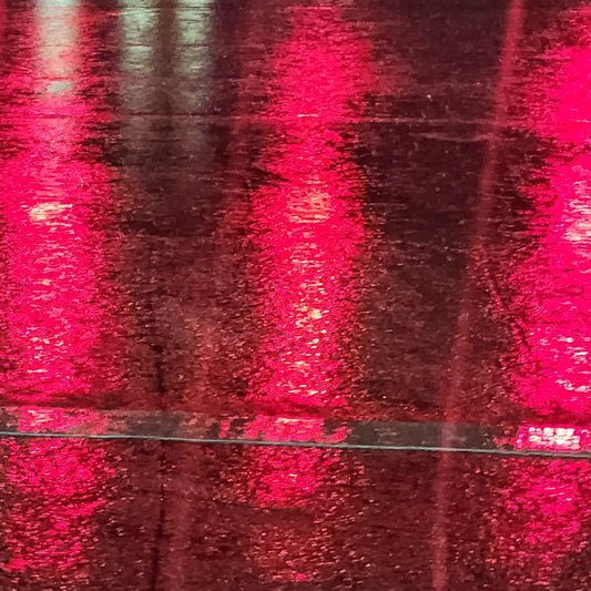Crimson lights reflected across wet pavement at night in Delray Beach, Florida, 2025, by Mac Beach.