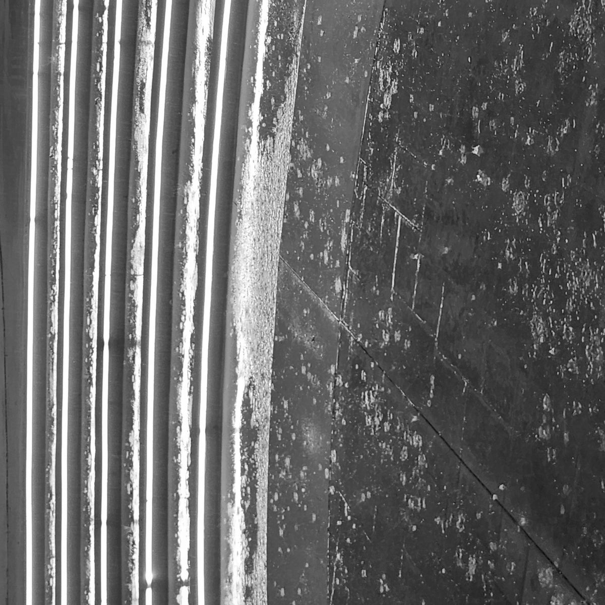 Rotated black-and-white view of a rain-soaked, LED-lit concrete staircase in Boynton Beach, Florida, photographed in 2025.