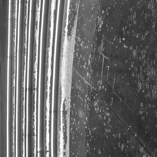 Rotated black-and-white view of a rain-soaked, LED-lit concrete staircase in Boynton Beach, Florida, photographed in 2025.
